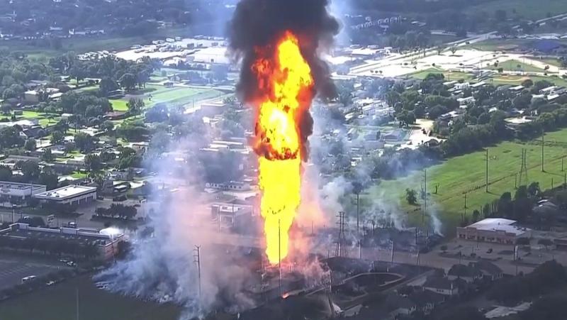 A pipeline explosion is shooting a towering pillar of flame over a Houston suburb