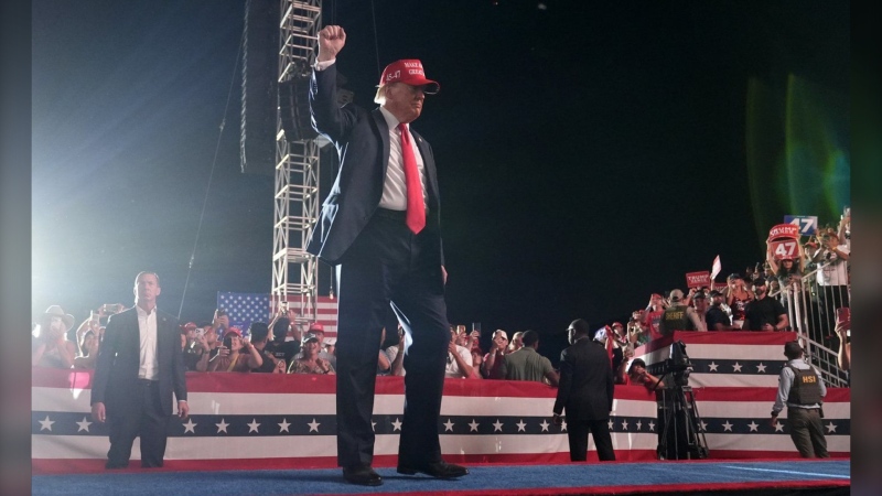 A man arrested with guns outside a Trump rally in California is suing the sheriff