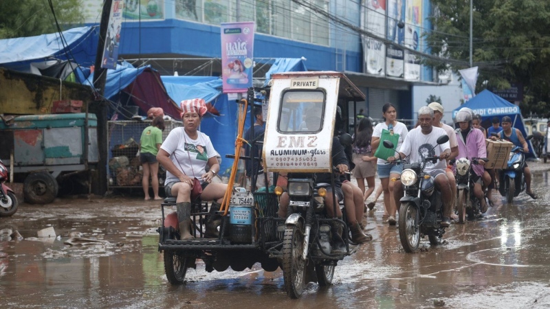 Floods in Philippines kill at least 9 and trap others on roofs as storm approaches