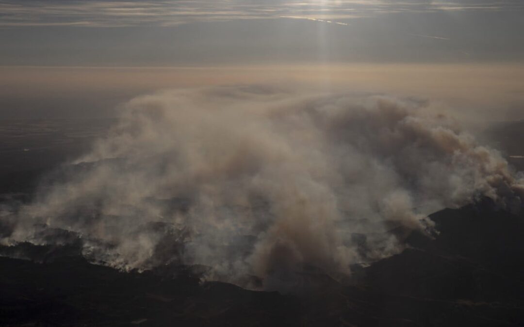 Firefighters advance on destructive blaze in California, aided by slower winds