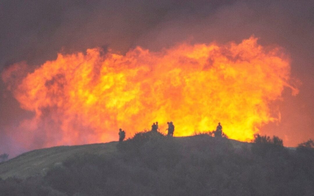 Firefighters race to contain Los Angeles wildfires before menacing winds return