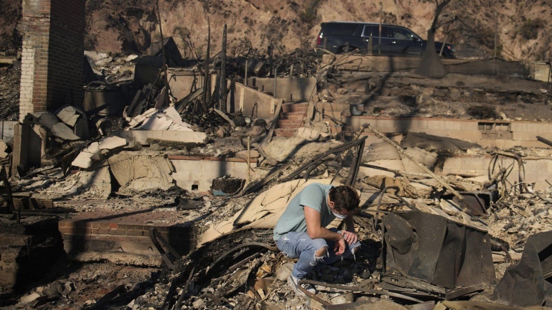 With their Los Angeles-area homes still smoldering, families return to search the ruins for memories